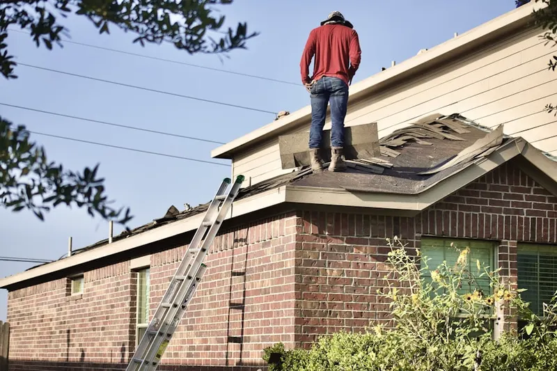 Professional roofer working on a residential roof in Pineridge